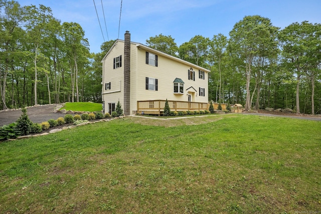 387 New London Tpke, Stonington, CT 06378 - view of home's exterior with a chimney, a deck, and a lawn