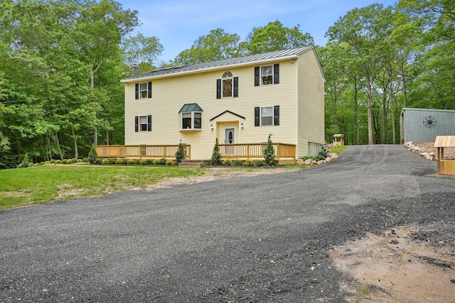 387 New London Tpke, Stonington, CT 06378 - view of front of house with a wooden deck, a standing seam roof, and metal roof