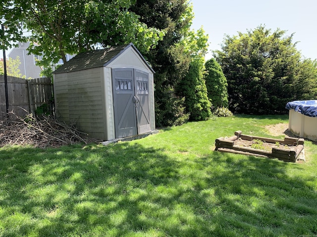 view of yard with a storage unit and an outbuilding