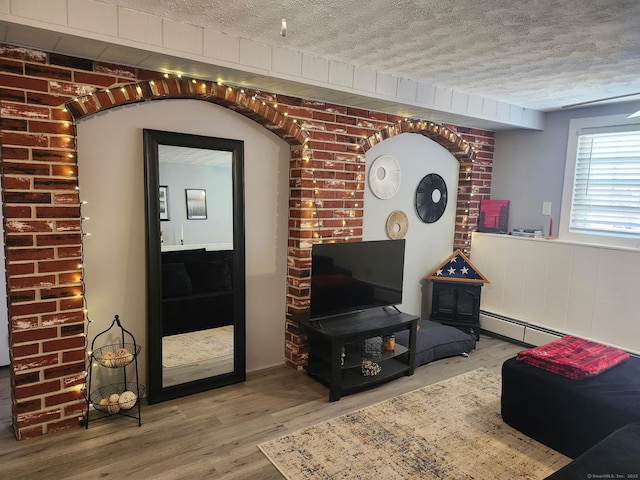 living room with a textured ceiling and wood finished floors