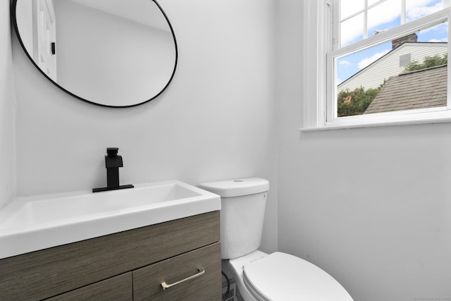 bathroom featuring toilet and vanity