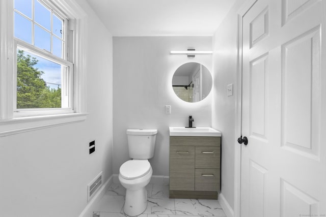 bathroom featuring baseboards, marble finish flooring, toilet, and vanity