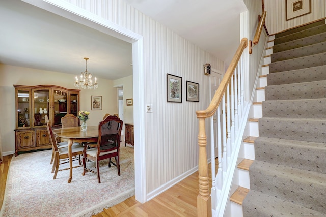 481 Clearbrook Rd, Orange, CT 06477 - dining space featuring light wood finished floors, stairs, a chandelier, and baseboards