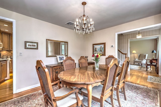 481 Clearbrook Rd, Orange, CT 06477 - dining area featuring light wood-style flooring, a chandelier, and baseboards