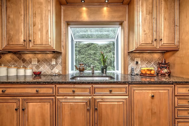 481 Clearbrook Rd, Orange, CT 06477 - kitchen featuring a sink, decorative backsplash, brown cabinetry, and dark stone counters