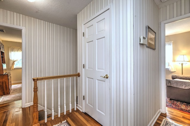 481 Clearbrook Rd, Orange, CT 06477 - hallway featuring wallpapered walls, wood finished floors, baseboards, and a textured ceiling