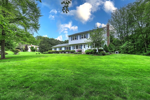 481 Clearbrook Rd, Orange, CT 06477 - colonial house featuring a chimney and a front yard