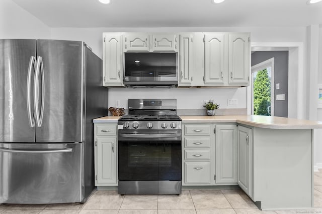 43 Atwater St, Milford, CT 06460 - kitchen featuring appliances with stainless steel finishes, light countertops, a peninsula, recessed lighting, and light tile patterned floors