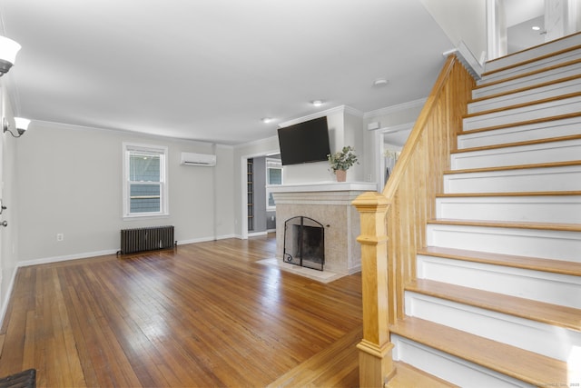 43 Atwater St, Milford, CT 06460 - unfurnished living room with radiator, a wall unit AC, stairway, ornamental molding, and wood-type flooring