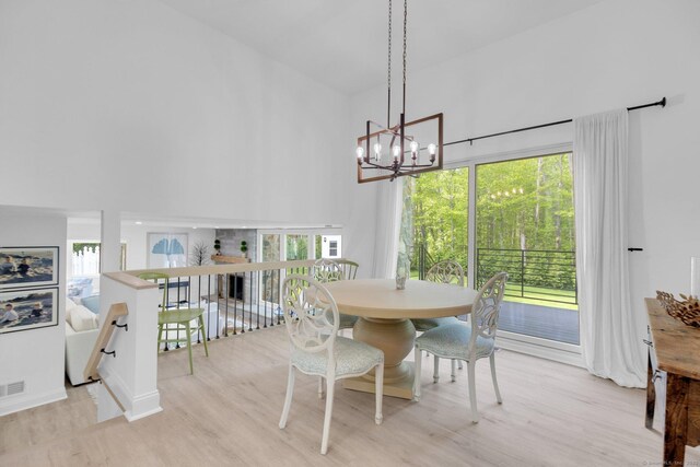 135 Gary Rd, Stamford, CT 06903 - dining space featuring a high ceiling, light wood-style floors, a chandelier, and plenty of natural light