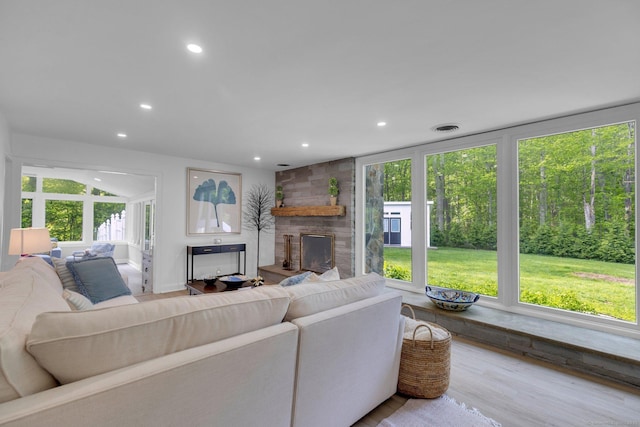 135 Gary Rd, Stamford, CT 06903 - living room with recessed lighting, a stone fireplace, and wood finished floors