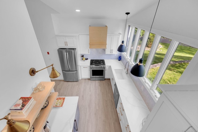 135 Gary Rd, Stamford, CT 06903 - kitchen with appliances with stainless steel finishes, a sink, plenty of natural light, white cabinetry, and recessed lighting