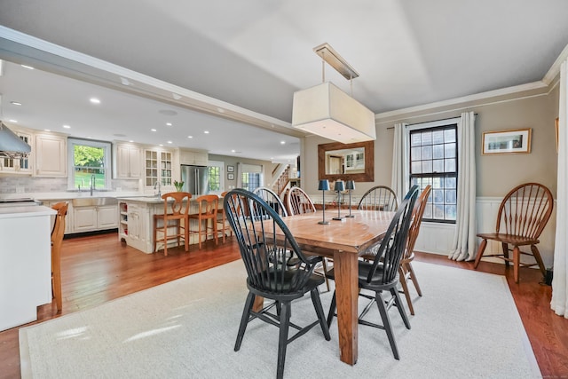 194 Josies Ring Rd, Monroe, CT 06468 - dining area with light wood finished floors, crown molding, a wainscoted wall, and recessed lighting