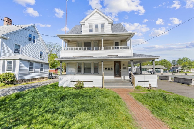 view of front of house featuring a porch, a balcony, and roof with shingles
