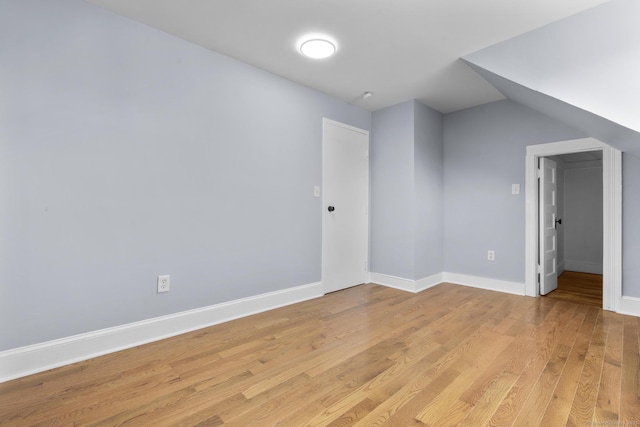 bonus room featuring light wood-style floors and baseboards