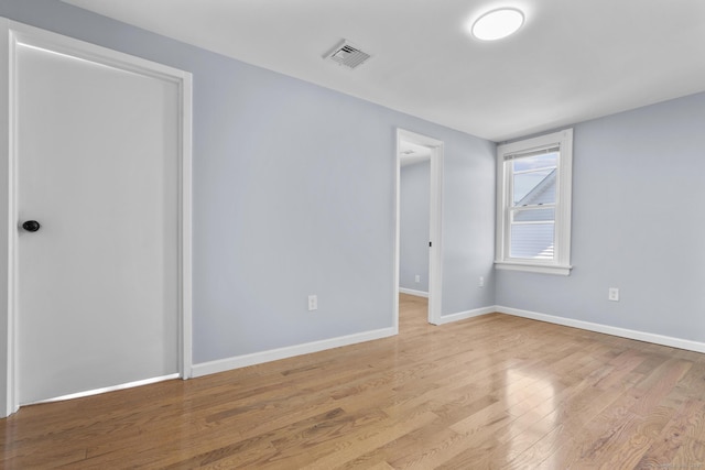 empty room with wood finished floors and baseboards