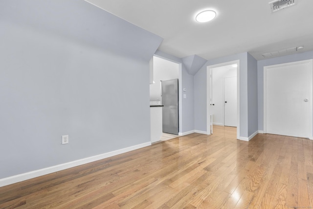 unfurnished room featuring light wood-type flooring and baseboards