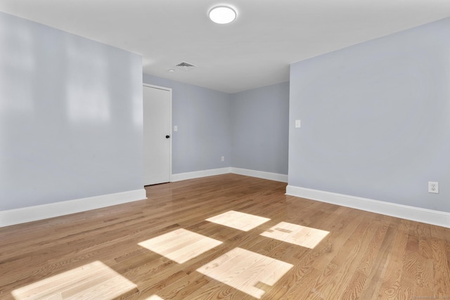 unfurnished room featuring baseboards and wood finished floors