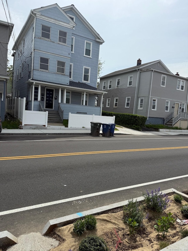 view of asphalt street featuring sidewalks and curbs