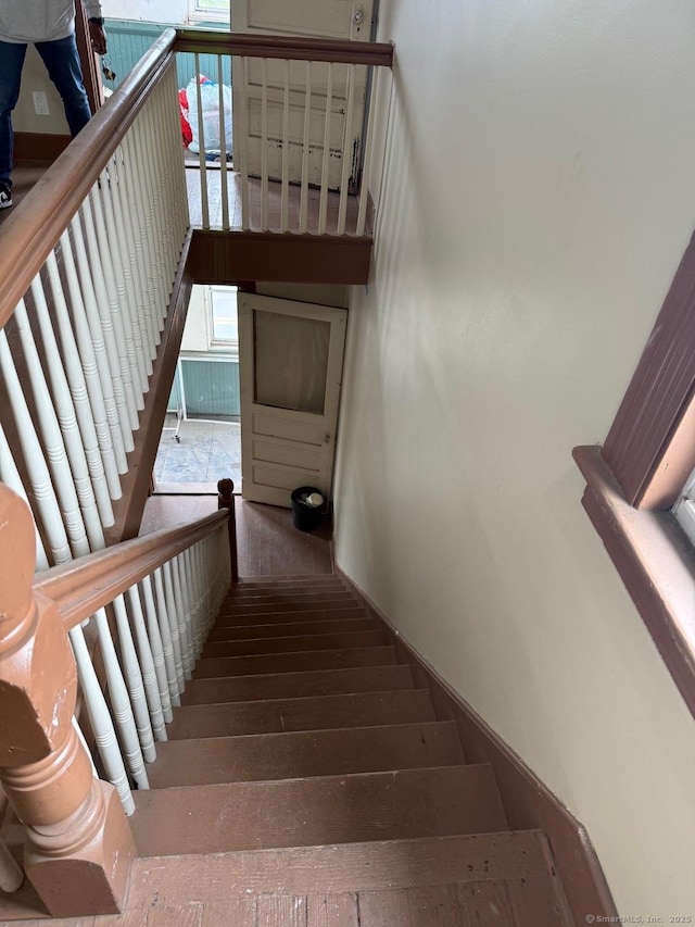staircase with hardwood / wood-style floors