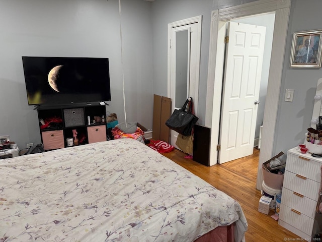 bedroom with light wood-style flooring and a closet