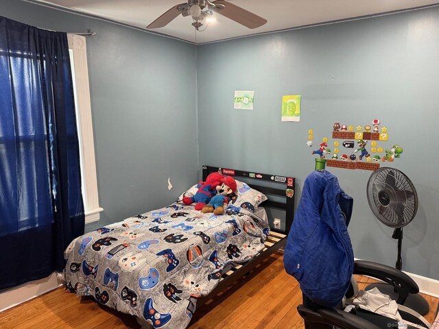 bedroom with wood finished floors and ceiling fan
