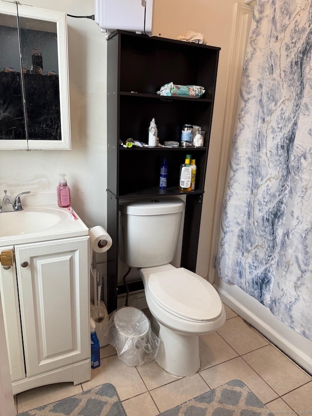 bathroom featuring tile patterned floors, toilet, and vanity