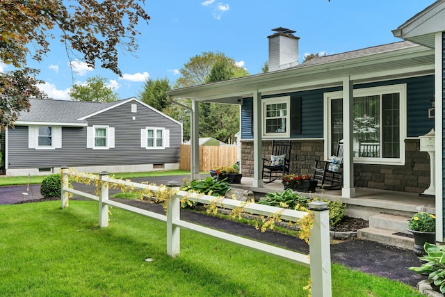 13 Carol St, Enfield, CT 06082 - rear view of property featuring covered porch, a chimney, stone siding, and roof with shingles