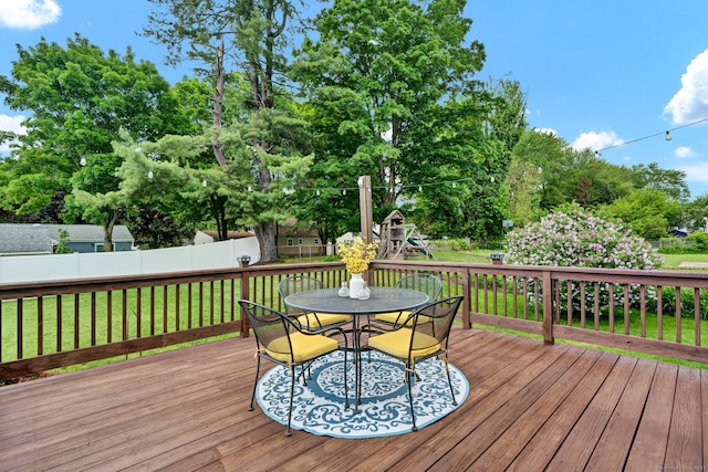 13 Carol St, Enfield, CT 06082 - wooden deck featuring outdoor dining space, view of wooded area, and a playground