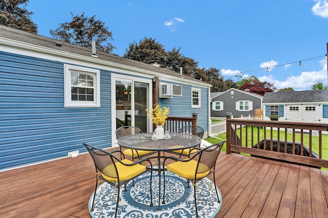 13 Carol St, Enfield, CT 06082 - deck with outdoor dining space, an outbuilding, a wall mounted AC, and a lawn