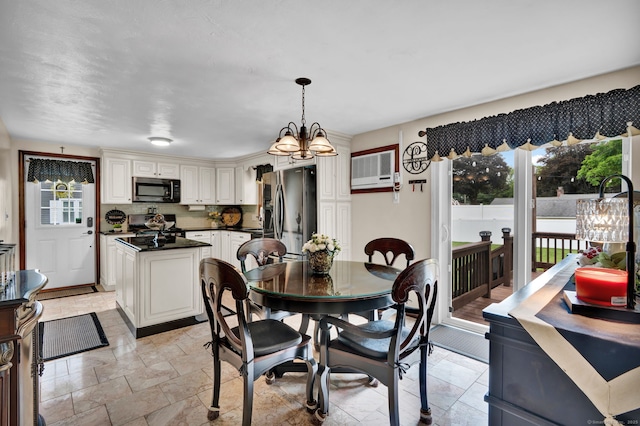 13 Carol St, Enfield, CT 06082 - dining room featuring a chandelier, stone tile flooring, and a wall mounted air conditioner