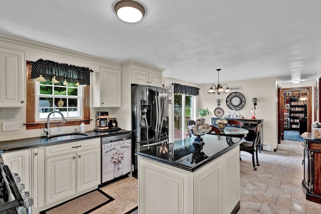 13 Carol St, Enfield, CT 06082 - kitchen with stainless steel dishwasher, black fridge, a kitchen island, a chandelier, and backsplash