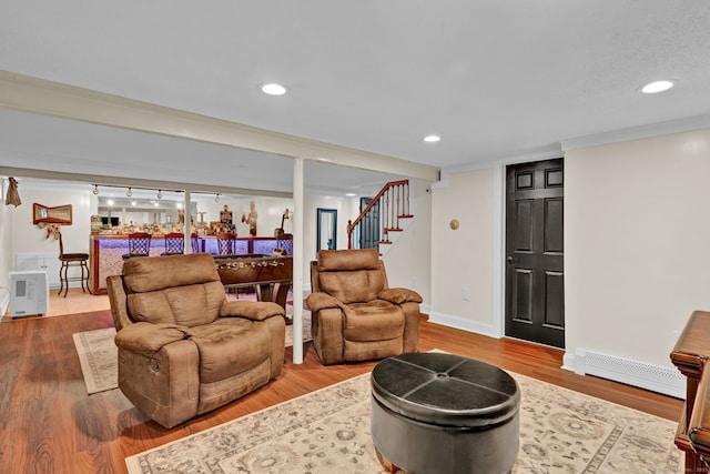 13 Carol St, Enfield, CT 06082 - living room with a baseboard heating unit, a bar, stairs, wood finished floors, and recessed lighting
