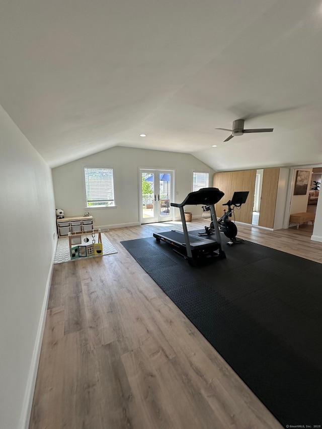 exercise room with lofted ceiling, wood finished floors, baseboards, and ceiling fan