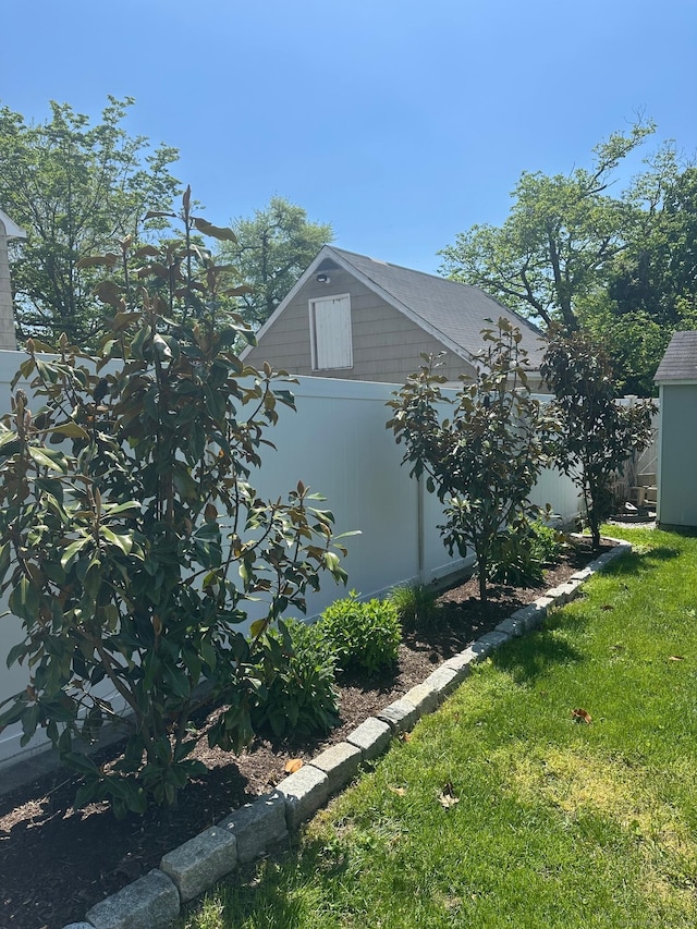 view of property exterior featuring a lawn and an outdoor structure