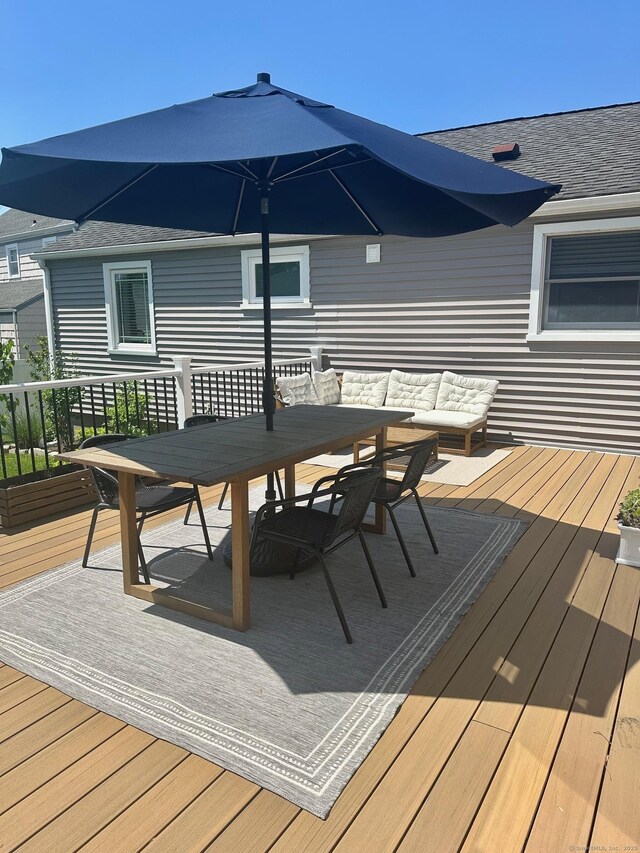 deck featuring outdoor dining area and an outdoor hangout area