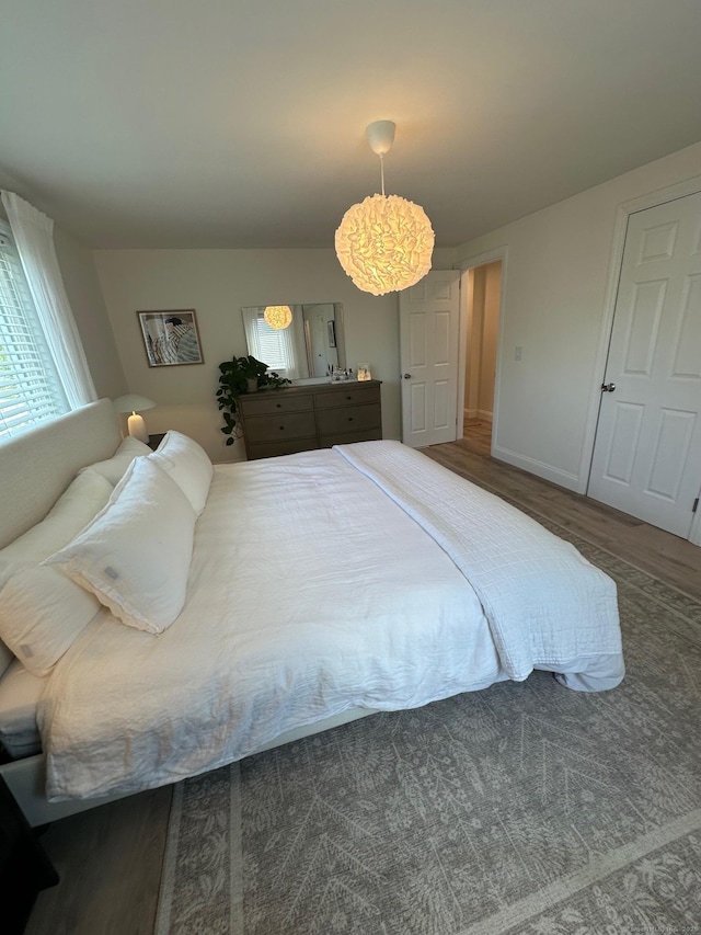 bedroom featuring baseboards and a chandelier