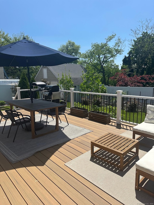 deck with outdoor dining area, grilling area, and an outdoor living space