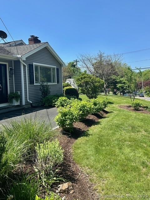view of home's exterior featuring a yard and a chimney