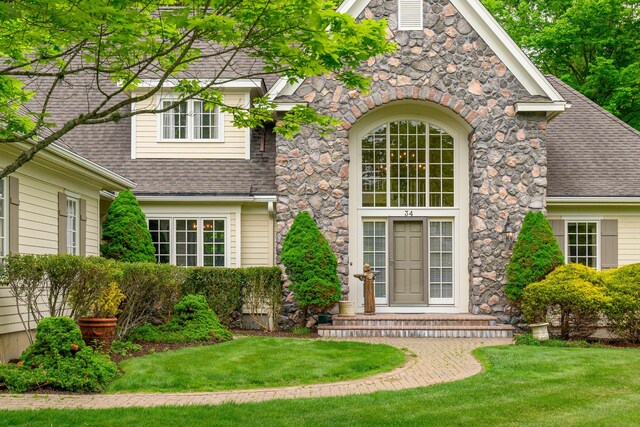 34 Avalon Dr, Middlebury, CT 06762 - view of front of property with a shingled roof, stone siding, and a front yard