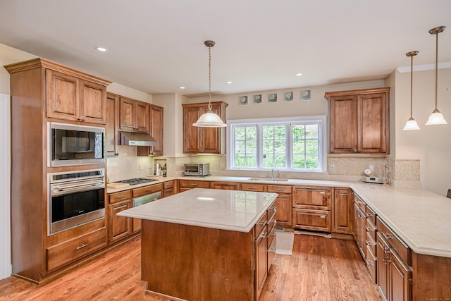 34 Avalon Dr, Middlebury, CT 06762 - kitchen featuring stainless steel oven, under cabinet range hood, black microwave, light wood-style flooring, and gas cooktop