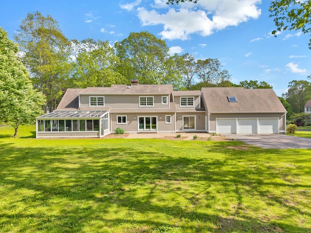 34 Willow Ln, East Lyme, CT 06333 - view of front of home with driveway, a sunroom, an attached garage, a front yard, and a chimney