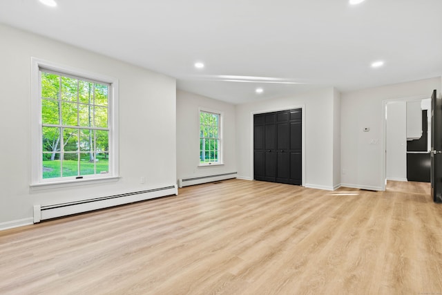 34 Willow Ln, East Lyme, CT 06333 - unfurnished living room featuring a baseboard radiator, light wood-type flooring, recessed lighting, and baseboards