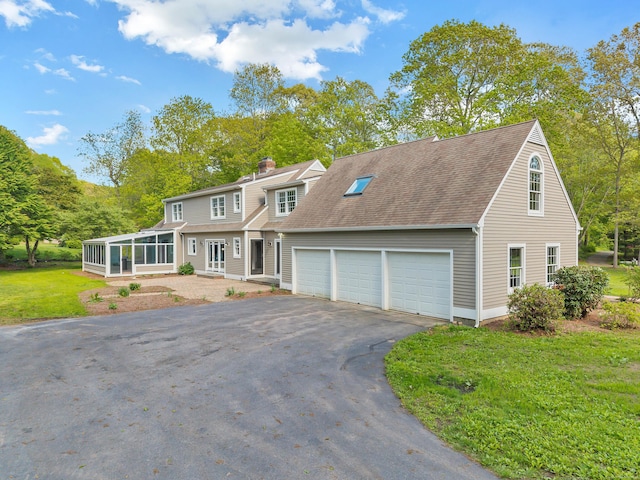 34 Willow Ln, East Lyme, CT 06333 - view of front of property featuring driveway, a garage, a sunroom, a chimney, and a front yard