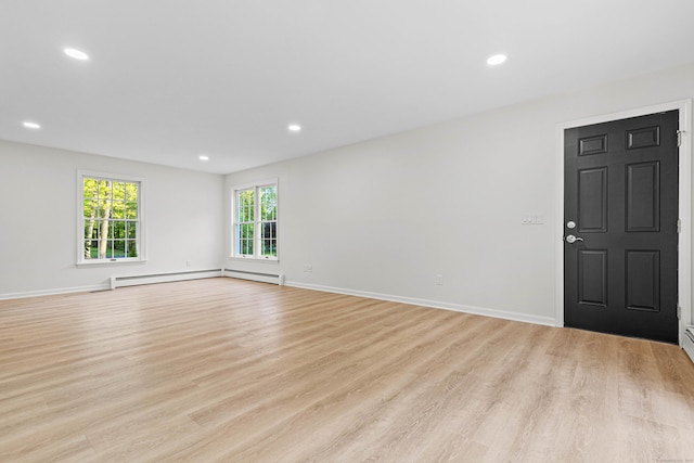 34 Willow Ln, East Lyme, CT 06333 - spare room featuring baseboard heating, light wood-style flooring, recessed lighting, and baseboards