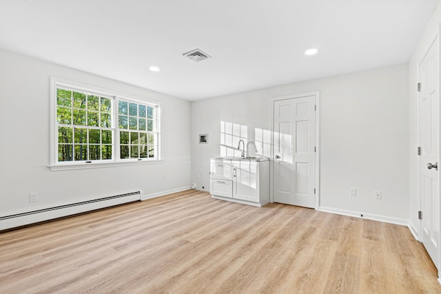 34 Willow Ln, East Lyme, CT 06333 - unfurnished bedroom featuring light wood finished floors, baseboards, baseboard heating, recessed lighting, and a sink