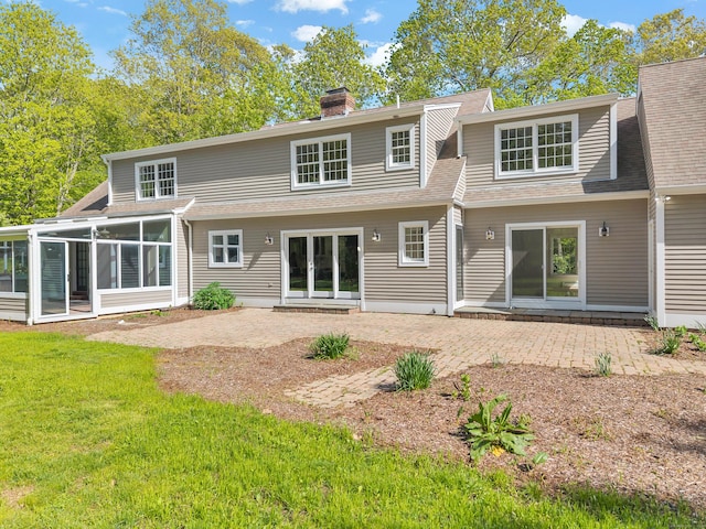 34 Willow Ln, East Lyme, CT 06333 - back of property with a patio area, a yard, a sunroom, roof with shingles, and a chimney