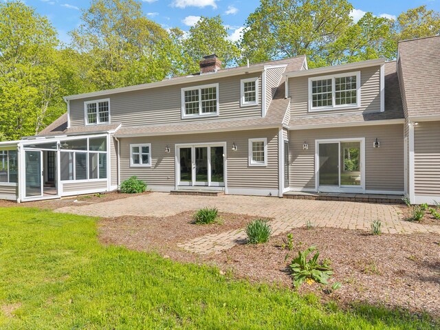 34 Willow Ln, East Lyme, CT 06333 - rear view of property featuring a patio, a yard, a sunroom, roof with shingles, and a chimney