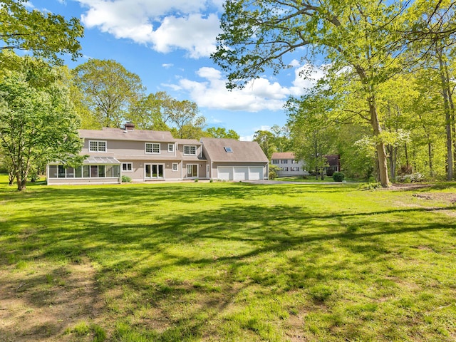 34 Willow Ln, East Lyme, CT 06333 - rear view of property with a garage, a sunroom, and a yard