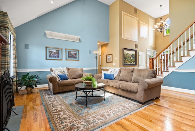 33 Pease Farm Rd, Ellington, CT 06029 - living room with high vaulted ceiling, wood finished floors, a chandelier, and stairway